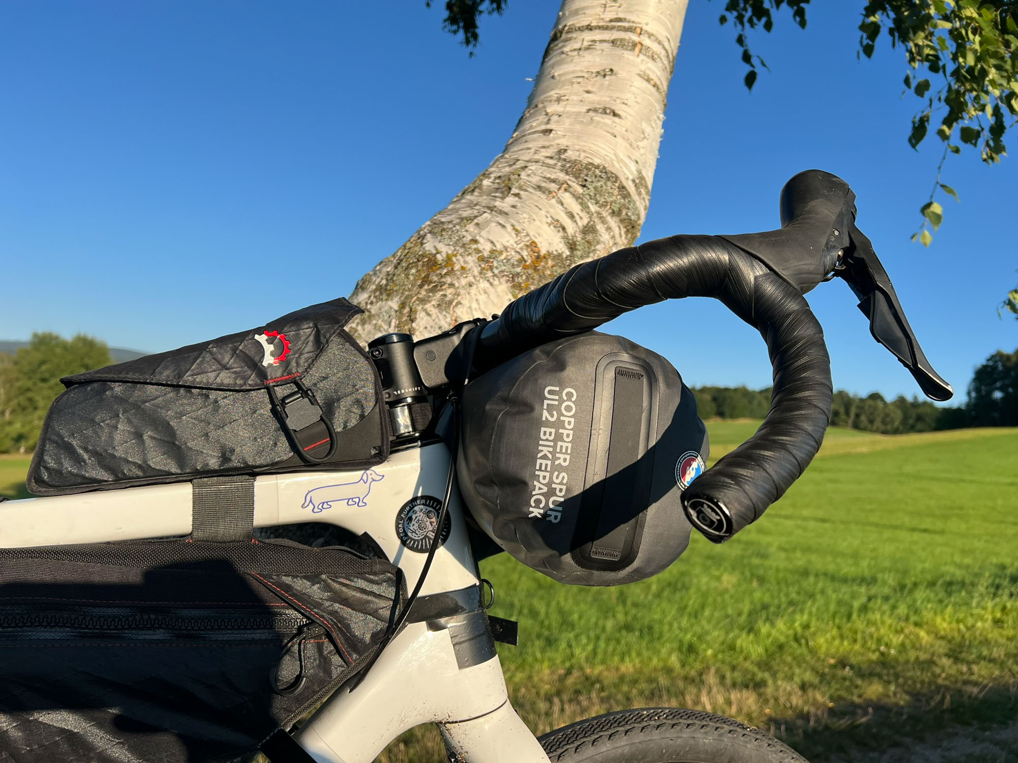 Stan Big Agnes Copper Spur Bikepack v obalu připevněný na řídítkách kola